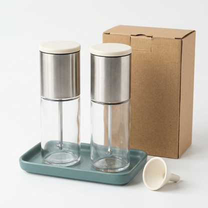 White-background grinder set concept with clear bodies, silver-tone housings and blank kraft packaging