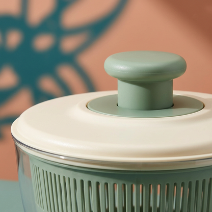 Close-up concept of central sage knob, ivory lid and visible slotted basket