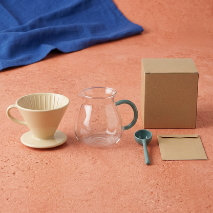 Separate coffee starter concept components arranged on coral counter with blank packaging